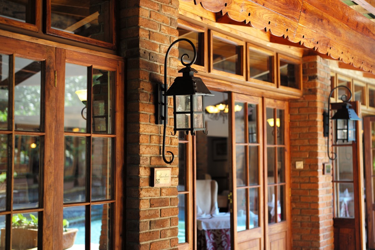 Warm wood-and-brick veranda at Arusha Coffee Lodge in Tanzania