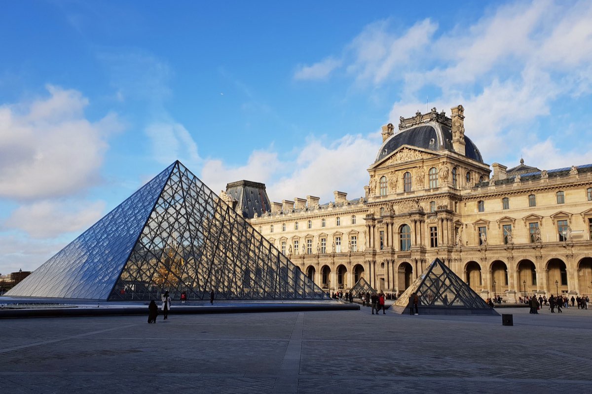 The Louvre courtyard and glass pyramid under a winter sky