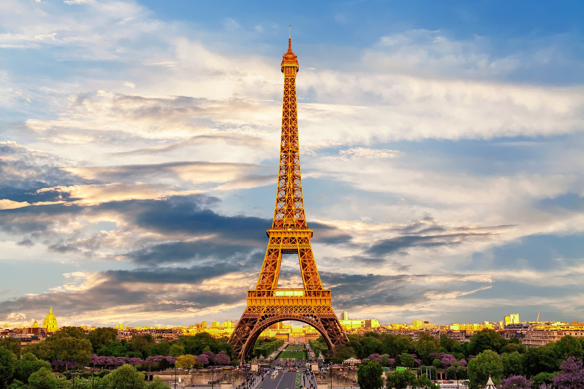Eiffel Tower above Paris beneath a dramatic evening sky