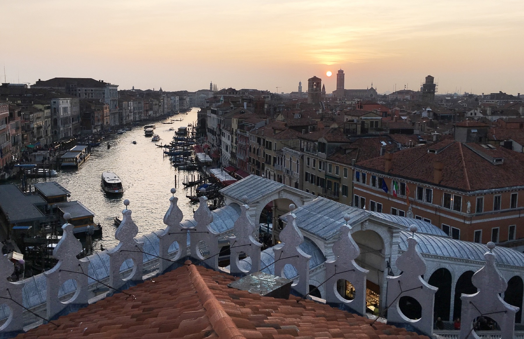 Grand Canal and Rialto Bridge rooftops in Venice at sunset