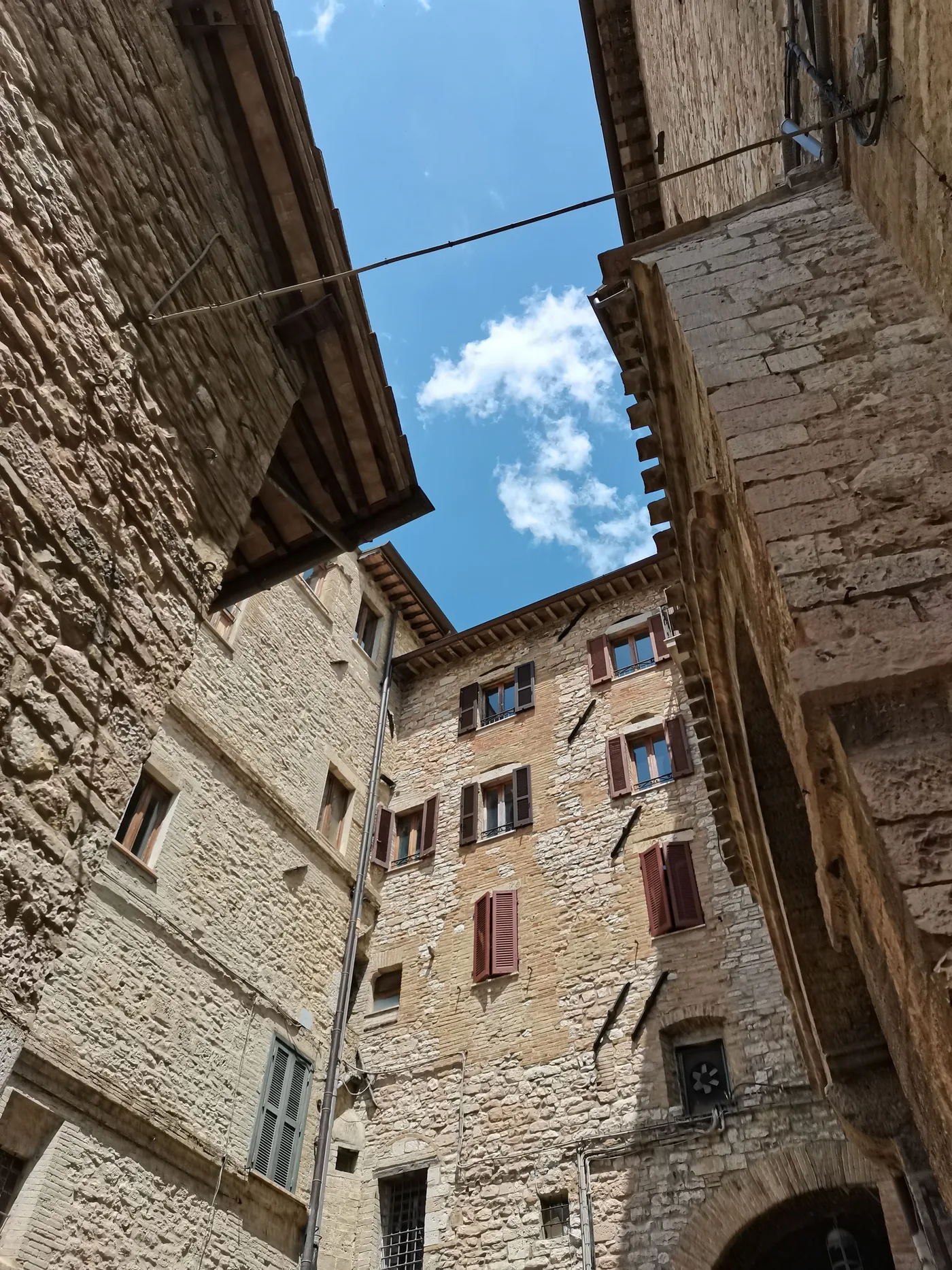 Stone houses and blue sky in historic Assisi