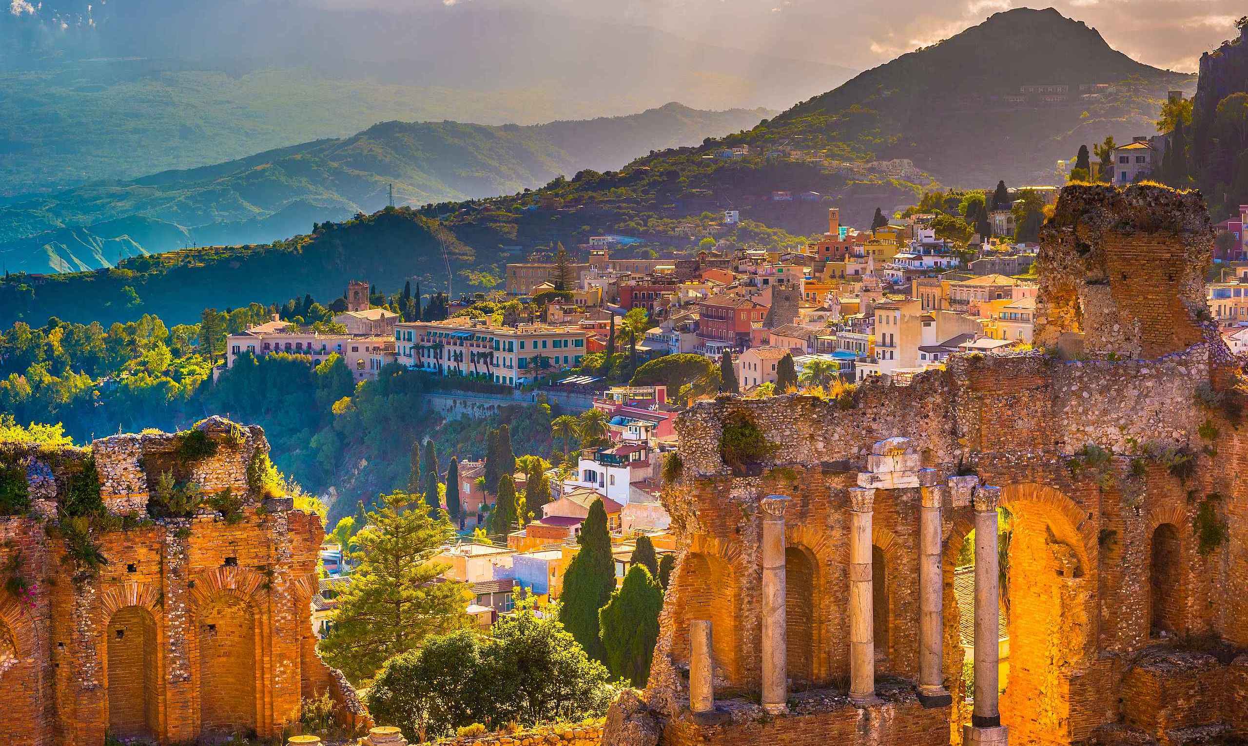 Taormina and its ancient theatre at golden hour